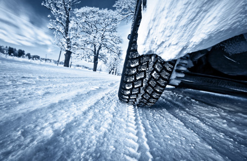 car-tire-driving-through-snow